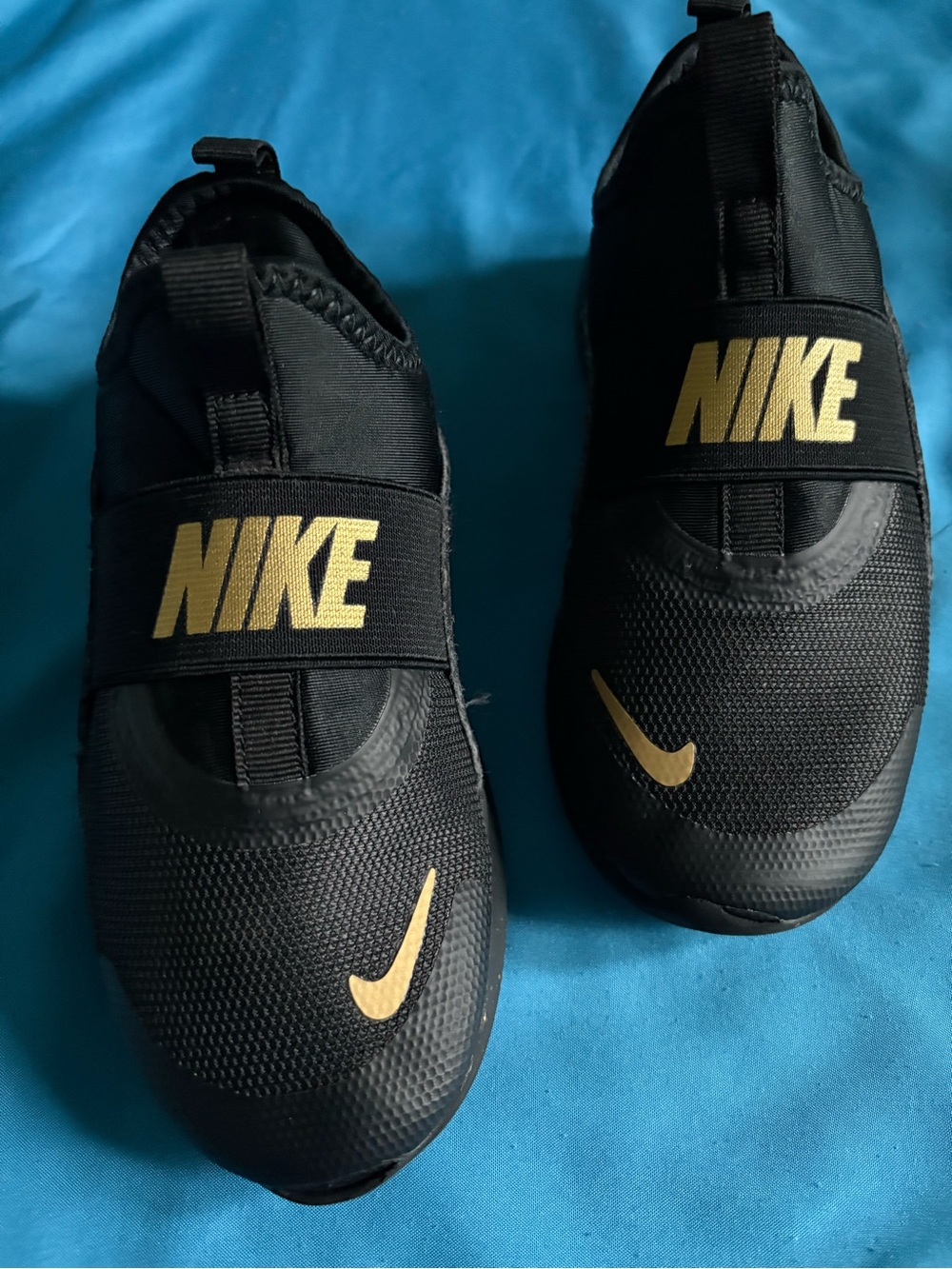 Nike Kids Black and Gold Slip-On Sneakers with Bold Logo
